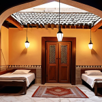 **

Prompt: A cozy, family-run guesthouse in the old city of Damascus, Syria. Capture the essence of warmth and hospitality. Include traditional Syrian architectural details and elements of local life visible in the surroundings. Consider the use of warm lighting to enhance the welcoming atmosphere.

**